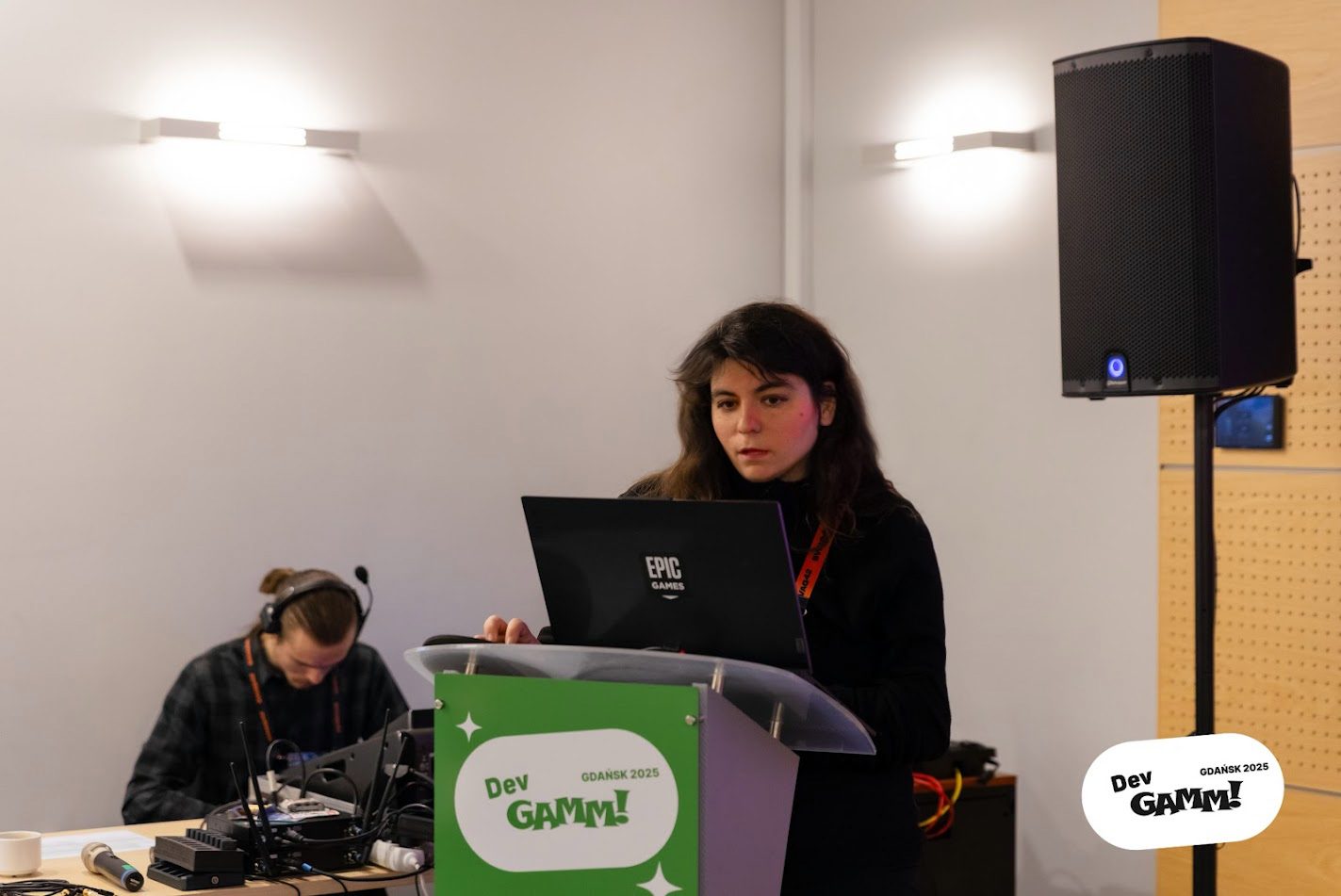 Elena Dimopoulou at the podium during her Fortnite Creative game design workshop at DevGAMM Gdańsk 2025