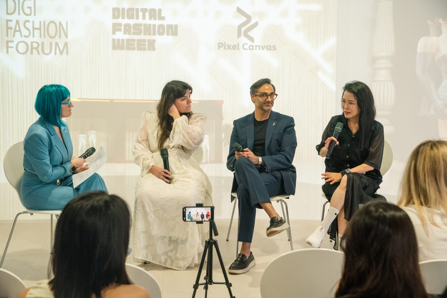 Elena Dimopoulou, in white, on a panel at Digital Fashion Week x DigiFashion Forum, Taipei, listening to a fellow panelist